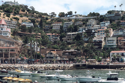 View of townscape by sea against sky