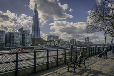 View of cityscape against cloudy sky