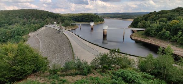 Scenic view of dam by river against sky