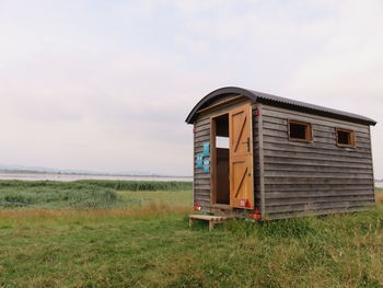 Bird hide on field against sky