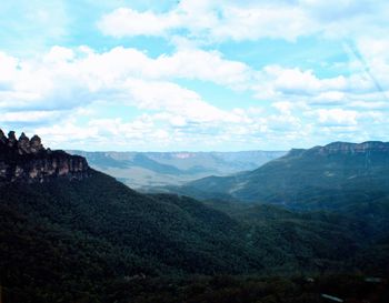 Scenic view of mountains against cloudy sky