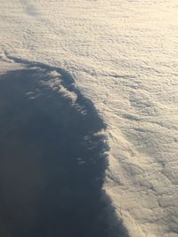 Scenic view of beach against sky during winter