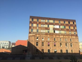 Low angle view of buildings against clear sky
