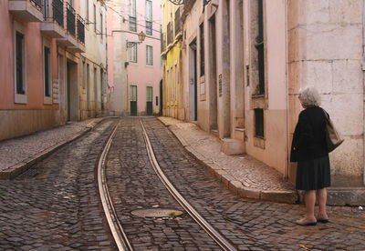 Rear view of woman on railroad track