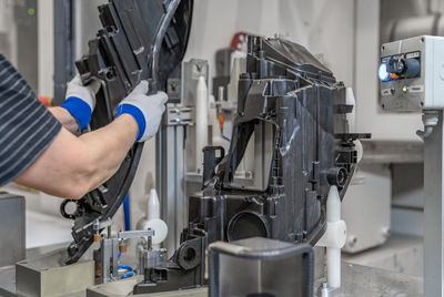 Cropped hand of man working in factory