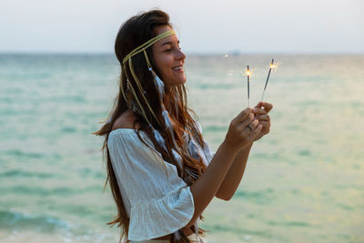 Side view of young woman holding ice cream