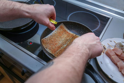 Midsection of man preparing food in kitchen