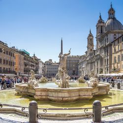 People outside church of sant agnese at piazza navona against clear sky