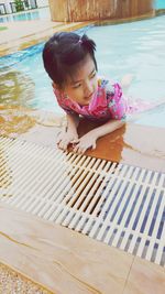 Portrait of cute girl in swimming pool