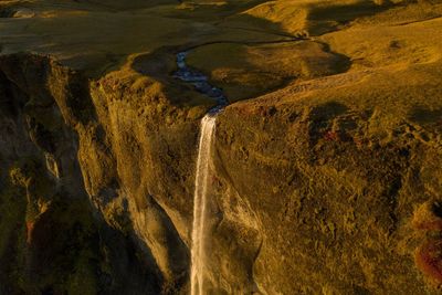 High angle view of waterfall falling from mountain