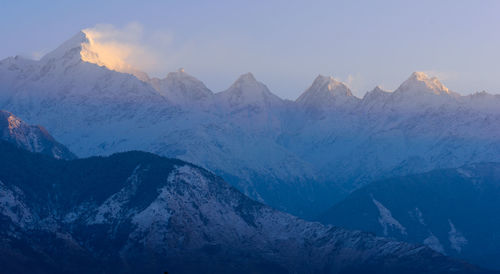 Scenic view of snowcapped mountains against sky