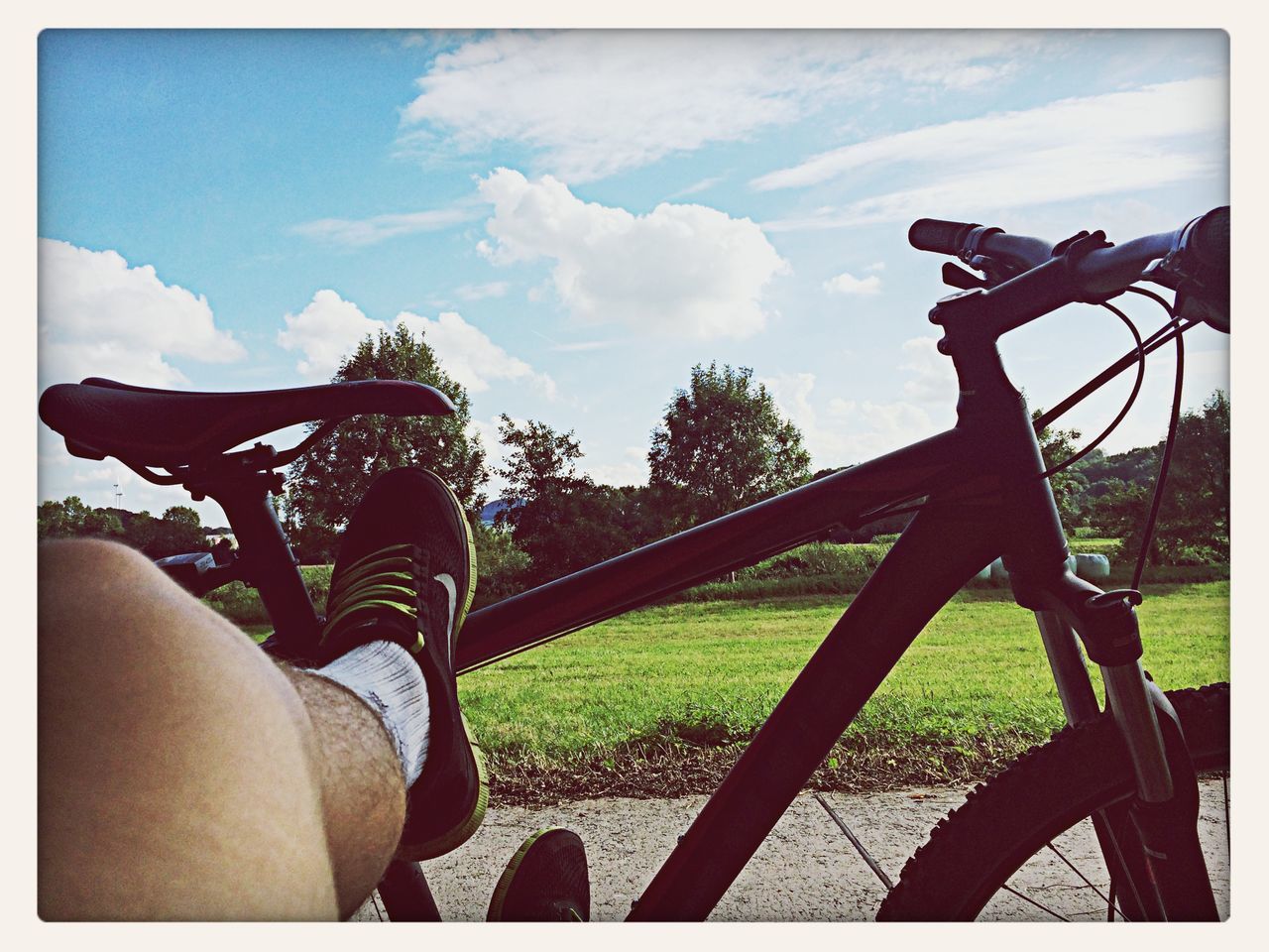 transfer print, sky, auto post production filter, bicycle, sunlight, cloud - sky, cloud, transportation, tree, part of, low angle view, shadow, day, land vehicle, mode of transport, nature, outdoors, silhouette, tranquility, beauty in nature