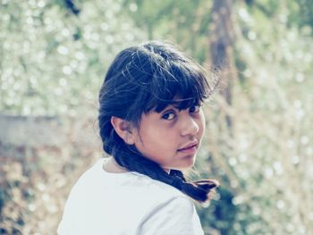 Close-up portrait of girl with braided hair