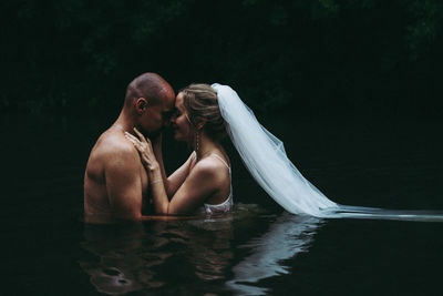 Couple kissing in water