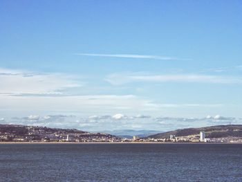 View of cityscape against blue sky