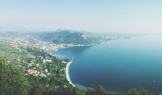 water, cityscape, city, sea, architecture, built structure, high angle view, building exterior, clear sky, aerial view, copy space, mountain, river, blue, scenics, coastline, crowded, residential district, nature, landscape