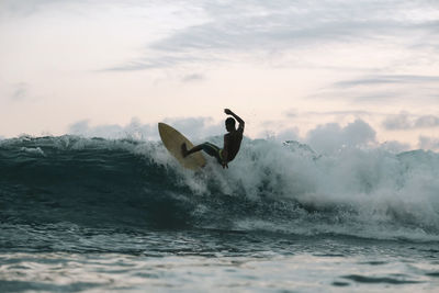 Surfer on a wave, lombok, indonesia