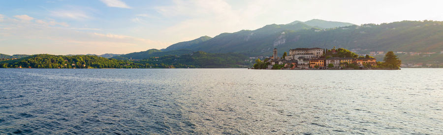 The island san giulio in lake d'orta seen from the waterfront of the little town in northern italy
