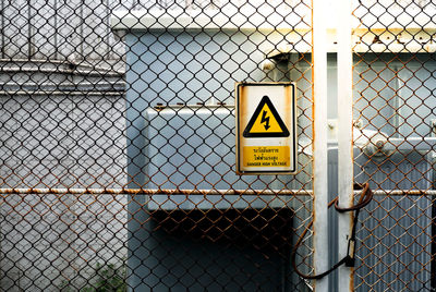 Warning symbol on chainlink fence
