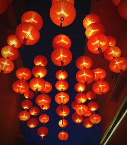 Low angle view of illuminated lanterns hanging at night