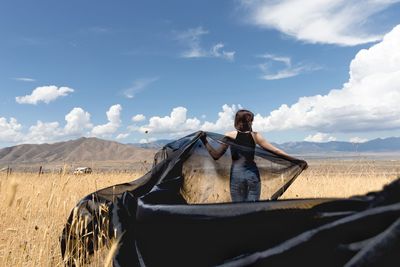 Woman on field against sky