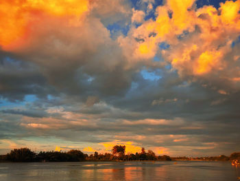 Scenic view of lake against orange sky