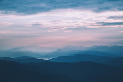 Scenic view of silhouette mountains against sky during sunset