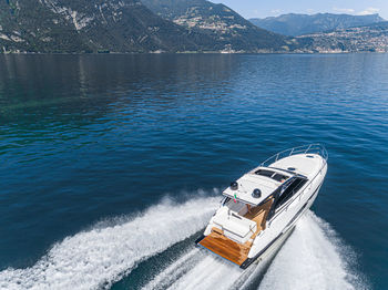 High angle view of nautical vessel on sea against mountain