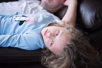 Girl lying down on bed at home