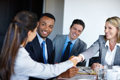 Businesswomen shaking hands in office