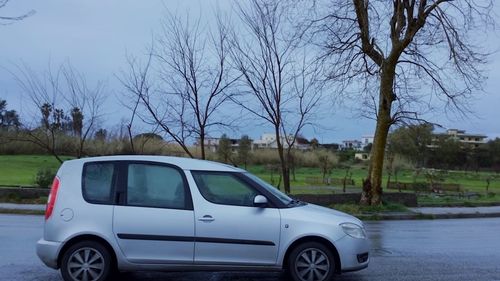 View of cars on road against blue sky