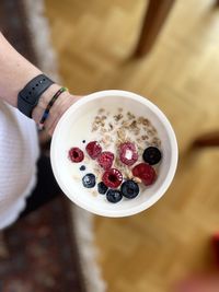 Close-up of hand holding strawberry
