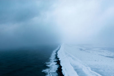 Scenic view of sea against sky during winter