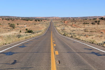 Empty country road against clear sky