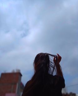 Rear view of woman looking at sky