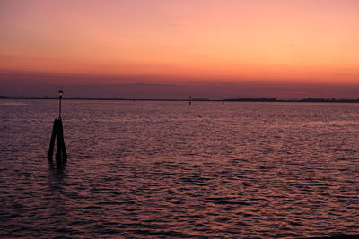 Scenic view of sea against orange sky