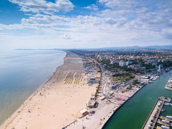 High angle view of sea and cityscape against sky