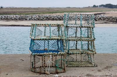 Stacked lobster traps on riverbank