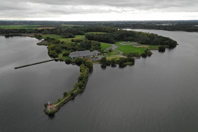 High angle view of river amidst land against sky