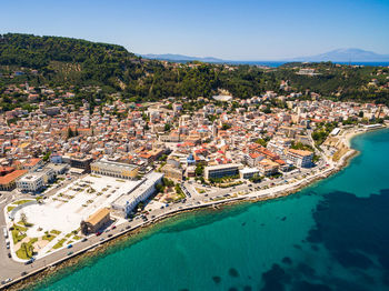 High angle view of townscape by sea against sky