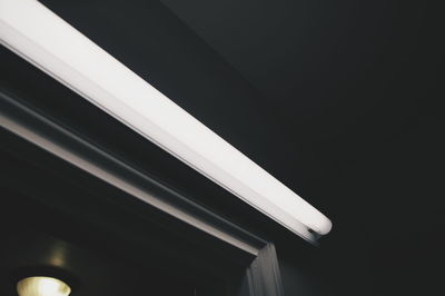 Low angle view of fluorescent light above window at home