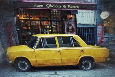 Yellow toy car on street