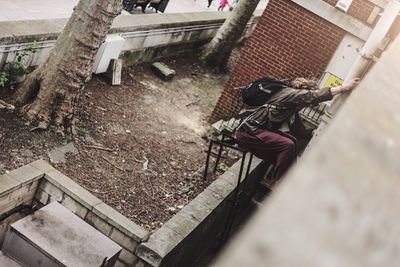 High angle view of man climbing on pipe