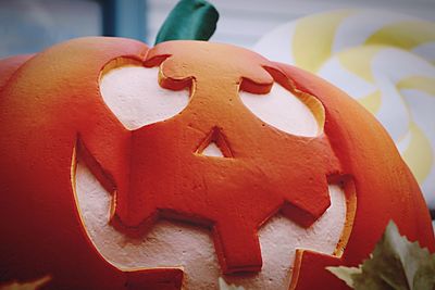 Close-up of red carving on white wall