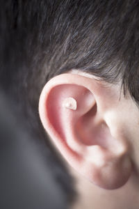 Close-up of boy ear with adhesive bandage 