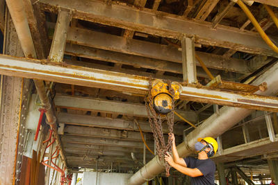 Low angle view of man working at workshop