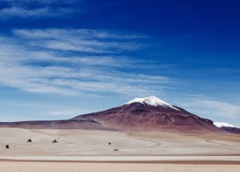 View of desert against cloudy sky