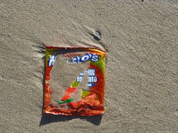 High angle view of text on sand at beach