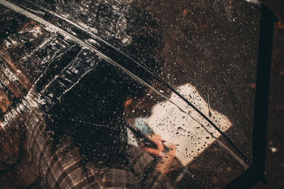 Reflection of man on glass window