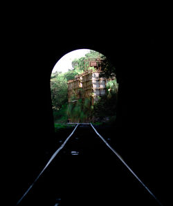Road in tunnel seen through car window
